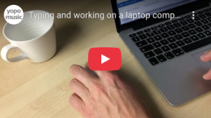 man typing on apple mac laptop