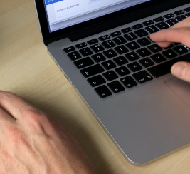Man working on Ale Mac Laptop